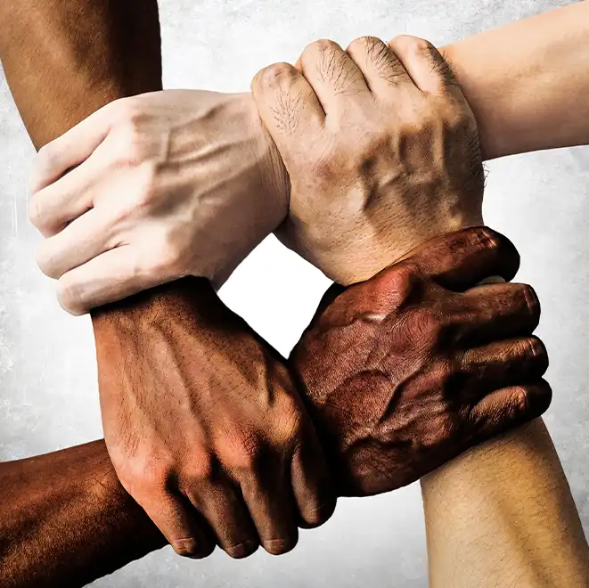 Hands put together holding wrists of different ethnicities